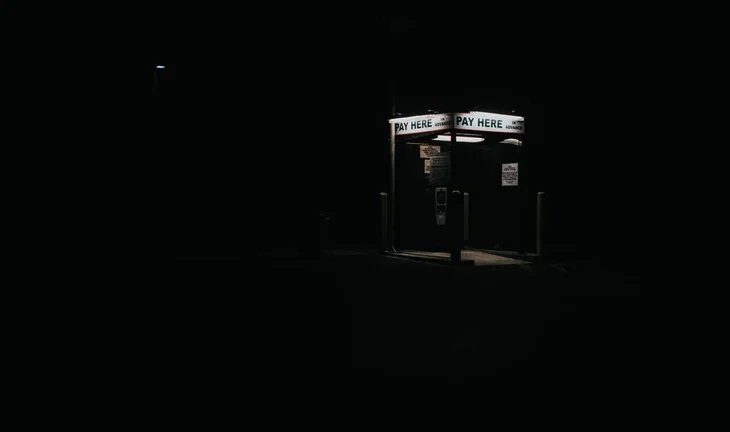 a telephone box that says pay here 