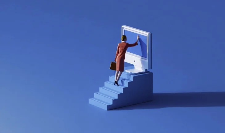 a small woman climbing stairs to a big blue computer screen 