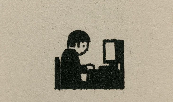 a student staring at a screen with a gold square in the background